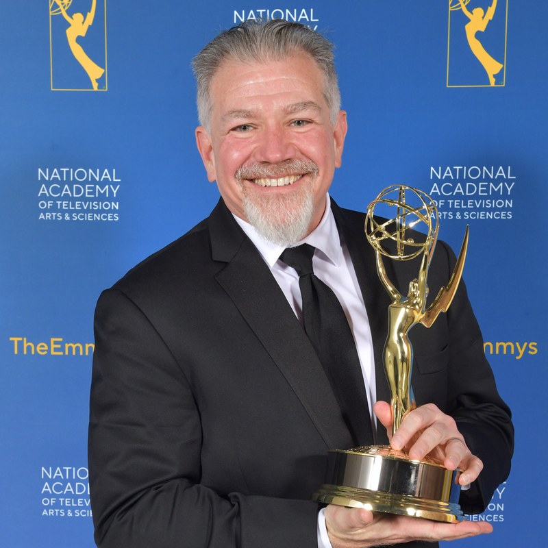 David Rudin holding a Technology & Engineering Emmy award